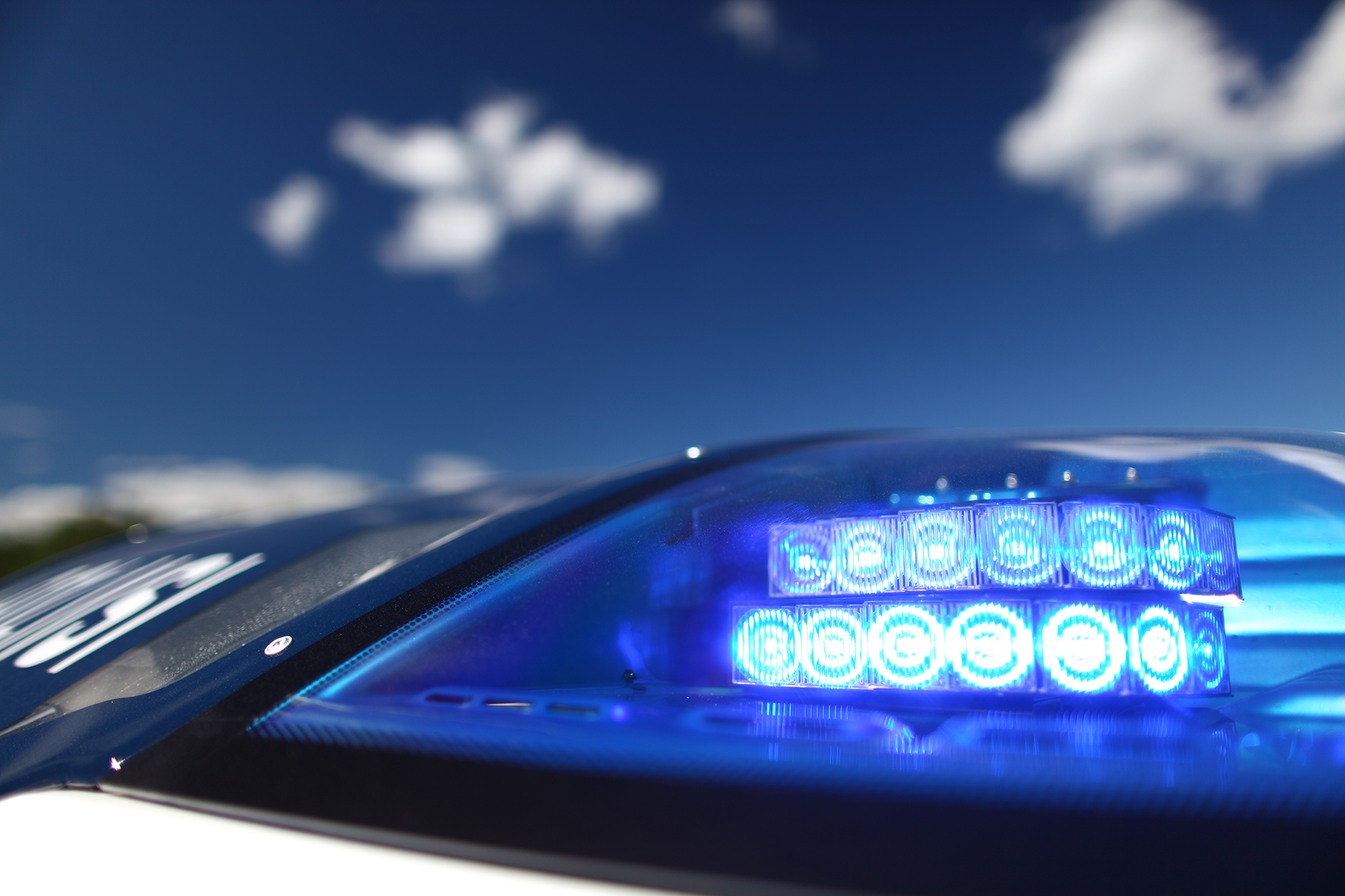 Close-up of a police car flashlight against a backdrop of blue sky. Photo the Police Museum