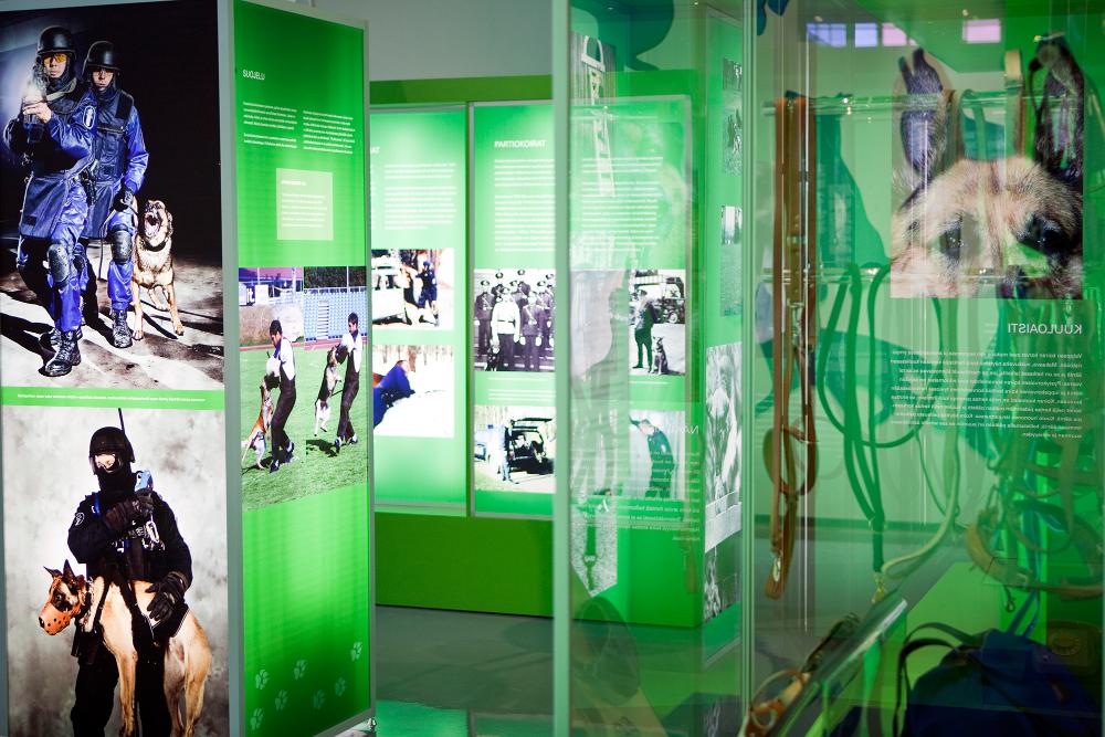 General view of the exhibition “The Nose Knows – A century of Finnish police dogs.” For example police dogs and dog handlers are seen in the photographs.