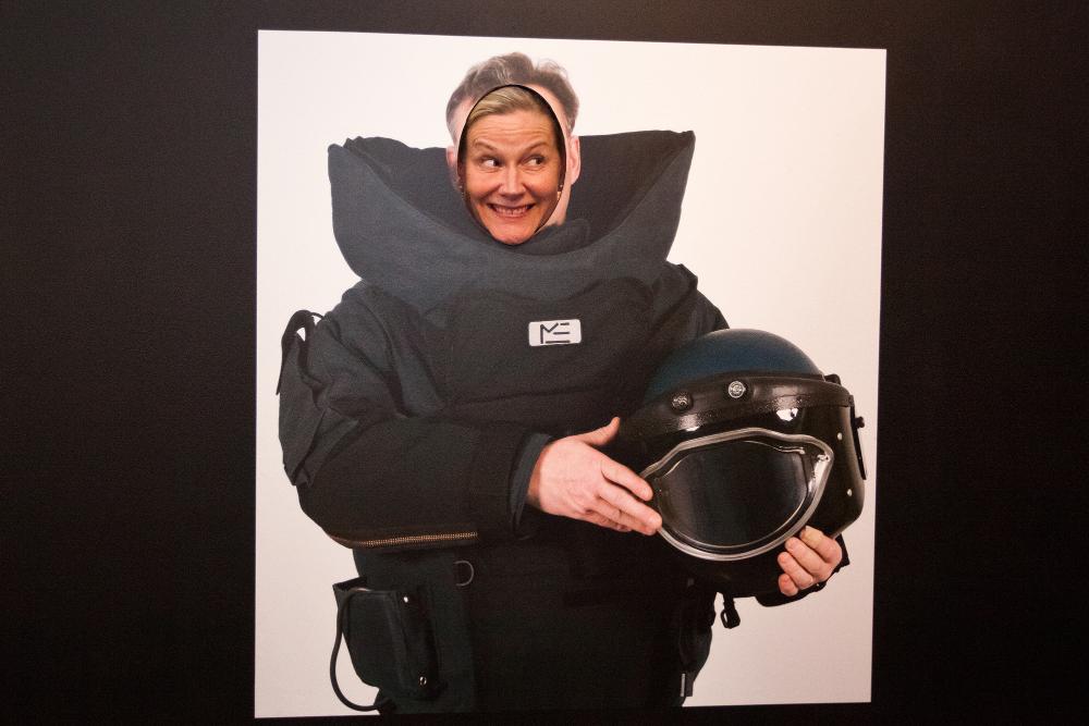 A museum visitor is posing in a photo stand-in at the “Demanding situations and the use of force” exhibition.