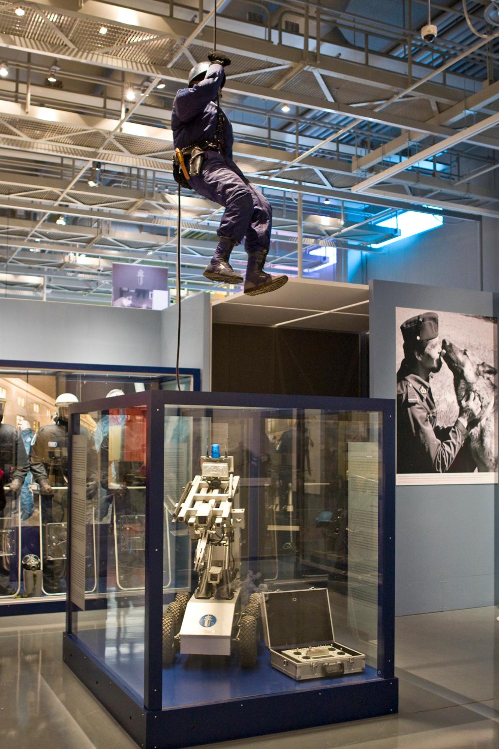 The exhibition displayed a bomb disposal robot and a police dummy of the National Special Intervention Unit ‘Karhu’, hanging on a rope from the ceiling.