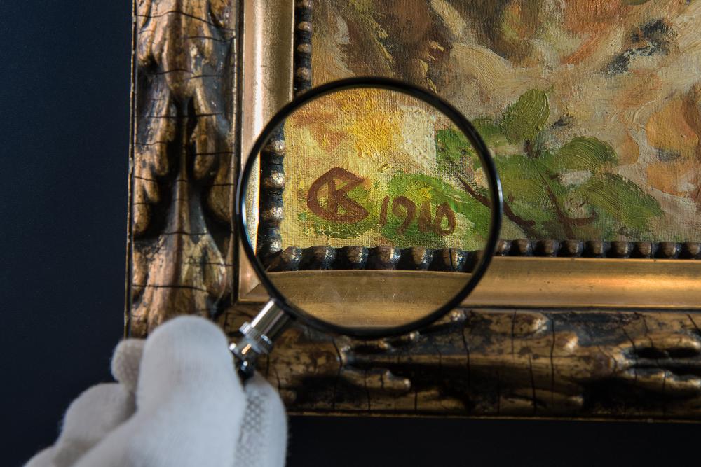 A work of art being investigated with a magnifying glass.